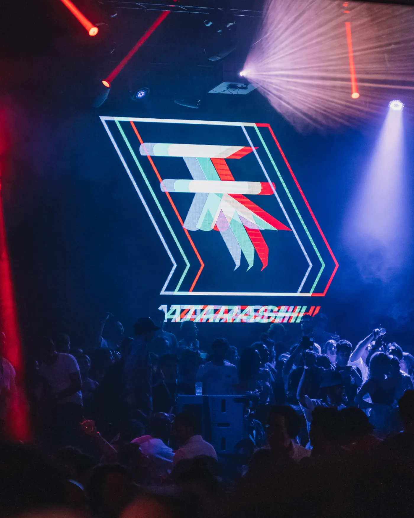 The ATARASHI mark projected on the club LED wall