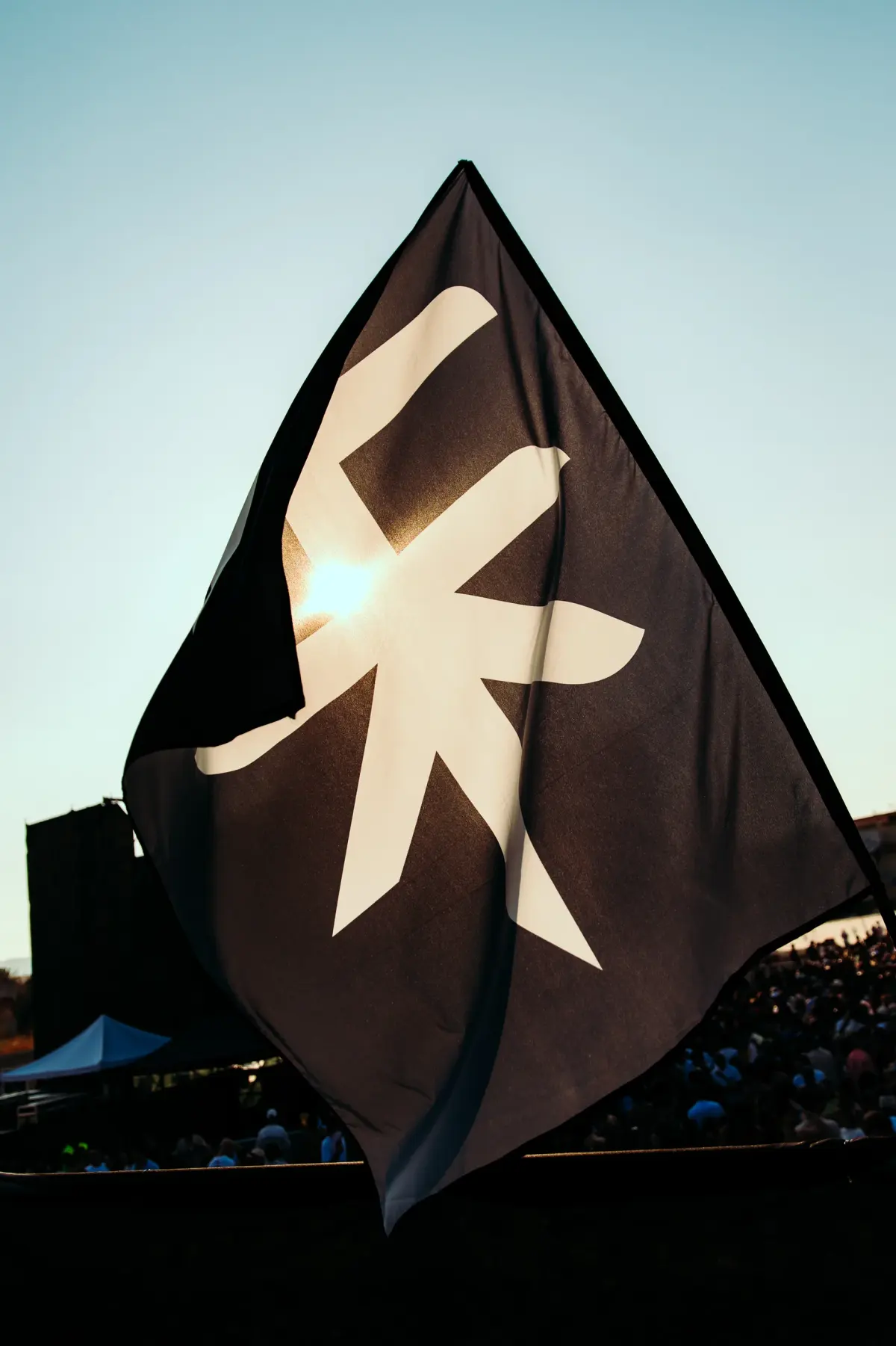 ATARASHI flag against the sun at the festival in Messina
